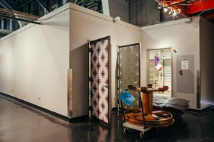 Modern office interior with patterned door and vintage barber chair.