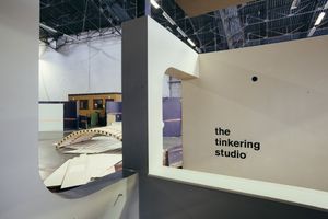 Modern interior space with 'The Tinkering Studio' text on white wall.