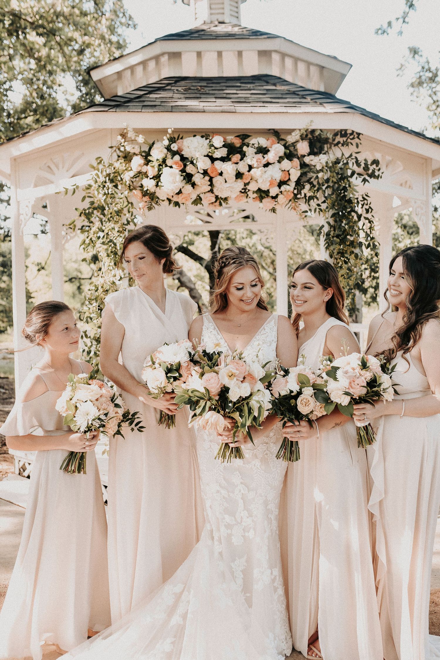 Editorial bridesmaids portraits featuring coordinated pink dresses at an outdoor spring wedding.