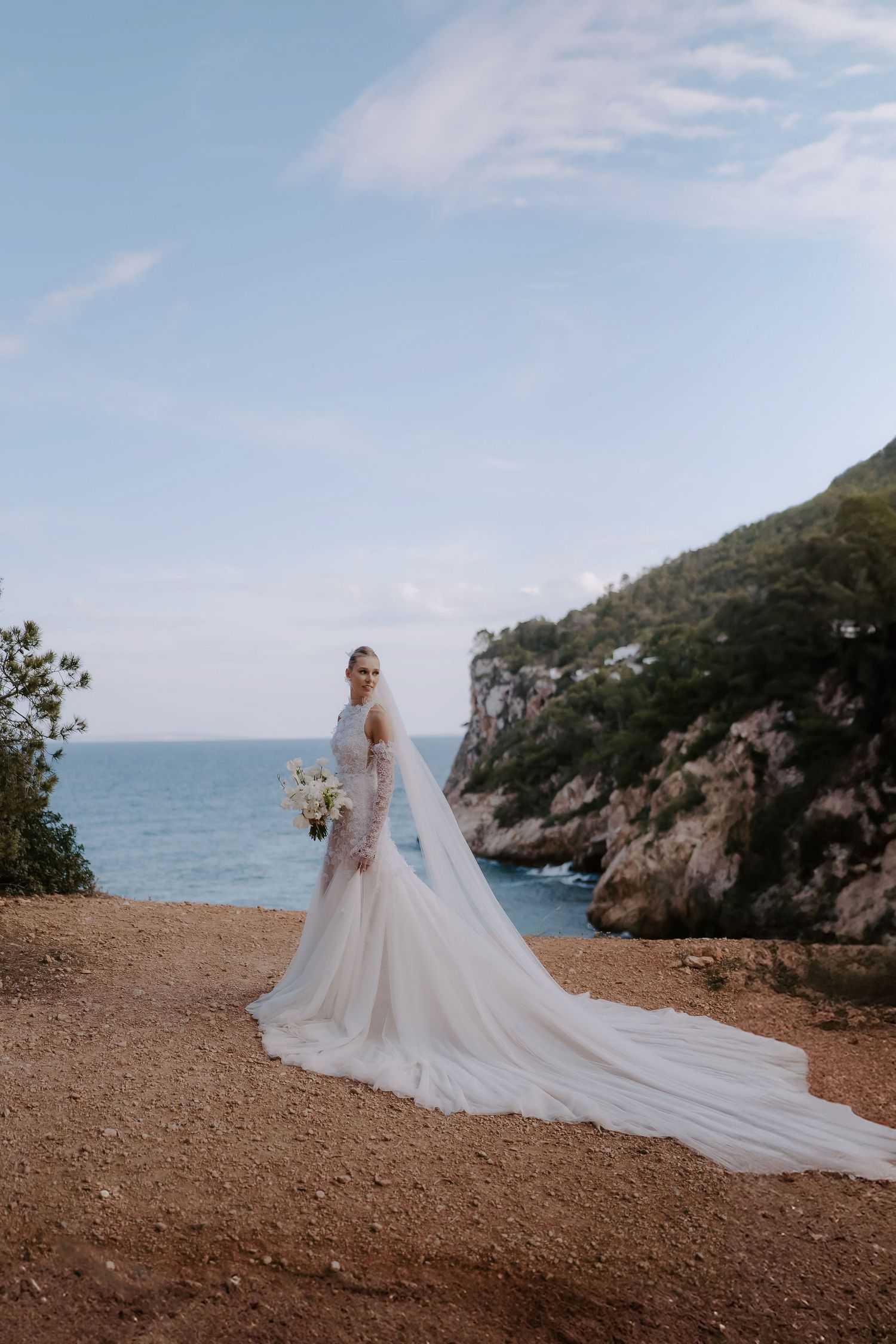 bride wearing Emma Beaumont dress on cliffs at Amante Ibiza