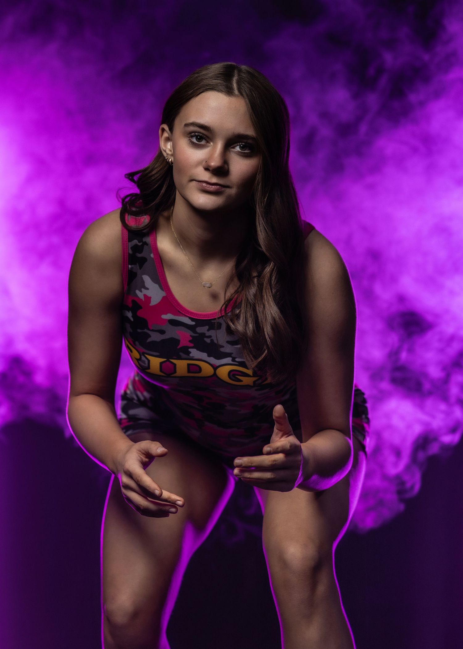 Athlete in purple sports attire strikes dynamic poses in a series of shots with atmospheric purple smoke effects.