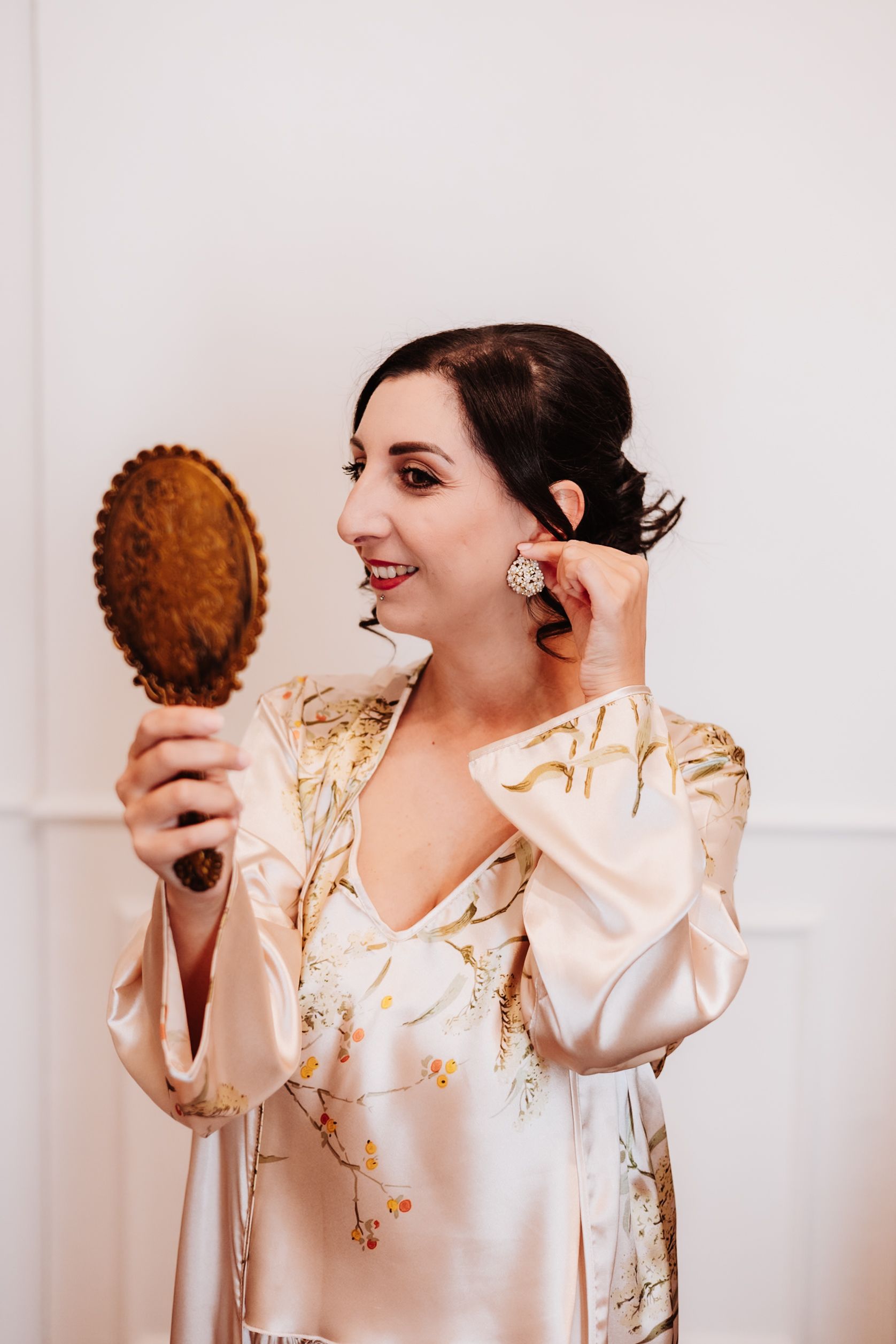 A sequence showing someone in a silk robe playfully posing with a coconut against a white background.