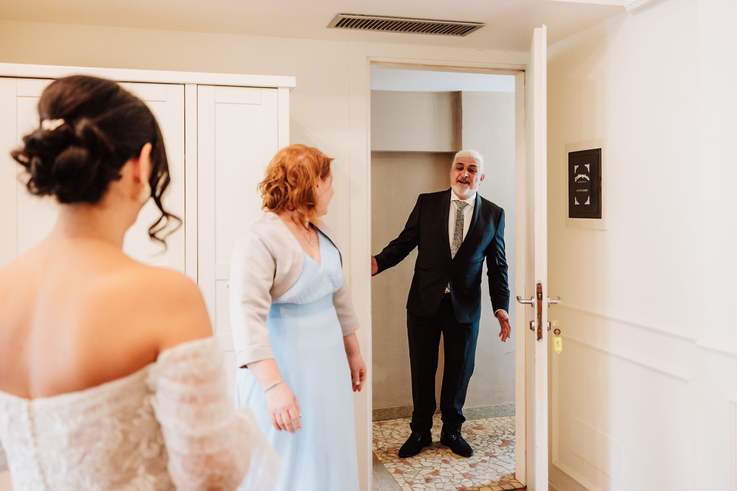 A series of candid wedding preparation moments showing details of a white dress and people getting ready in a bright room.