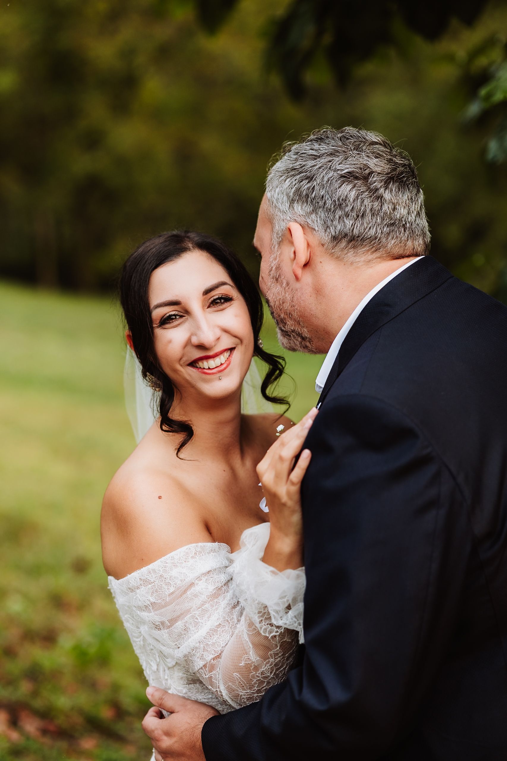 A romantic wedding moment captured in a series of four photos showing a couple embracing outdoors in an autumn setting.