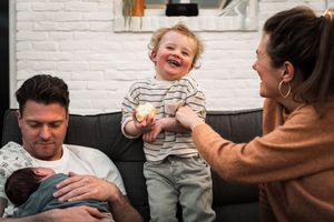 A playful sequence of photos showing a child laughing and interacting with someone on a gray couch.