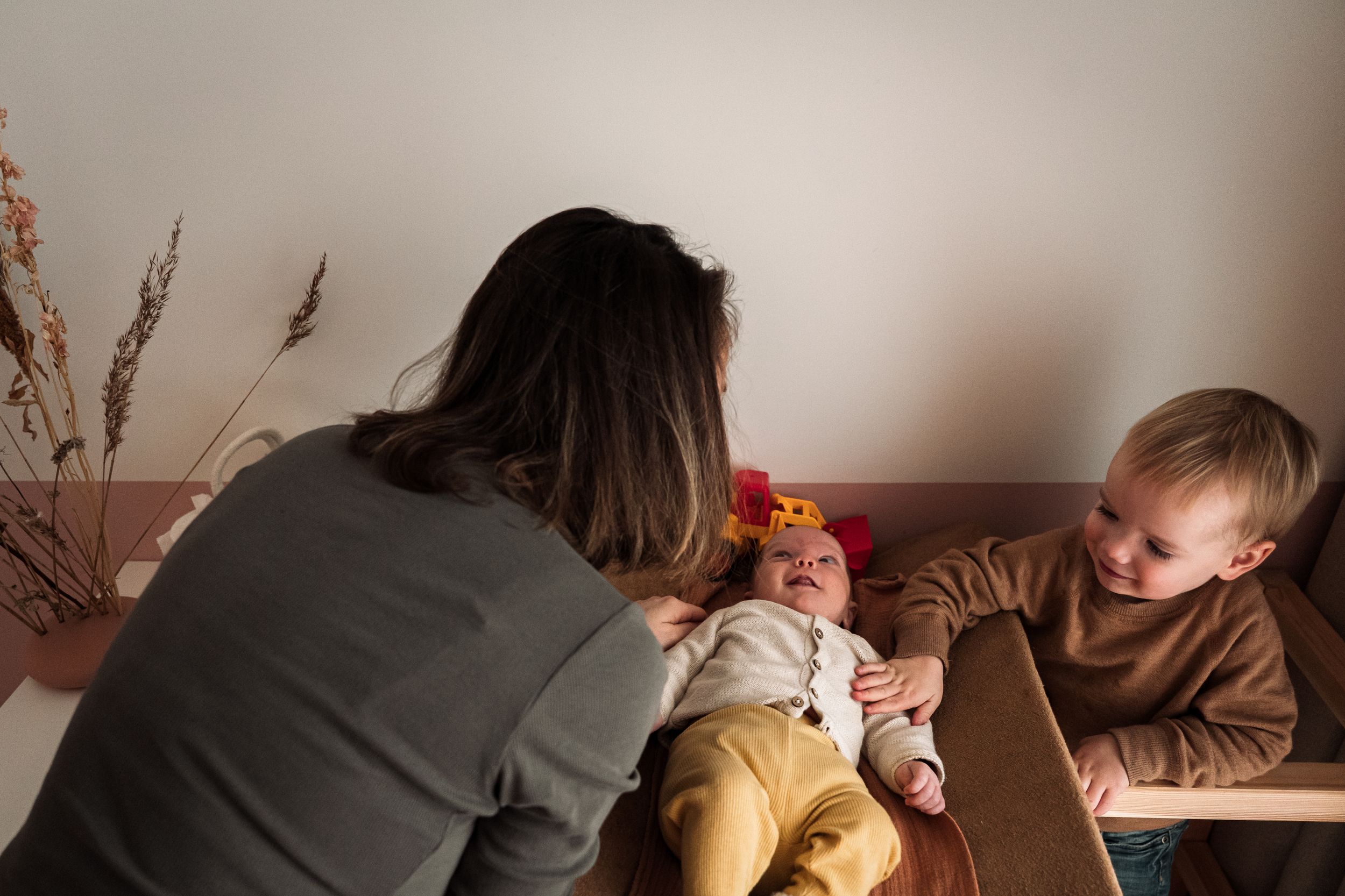 A collection of candid family moments captured in a series of warm-toned photographs arranged side by side.