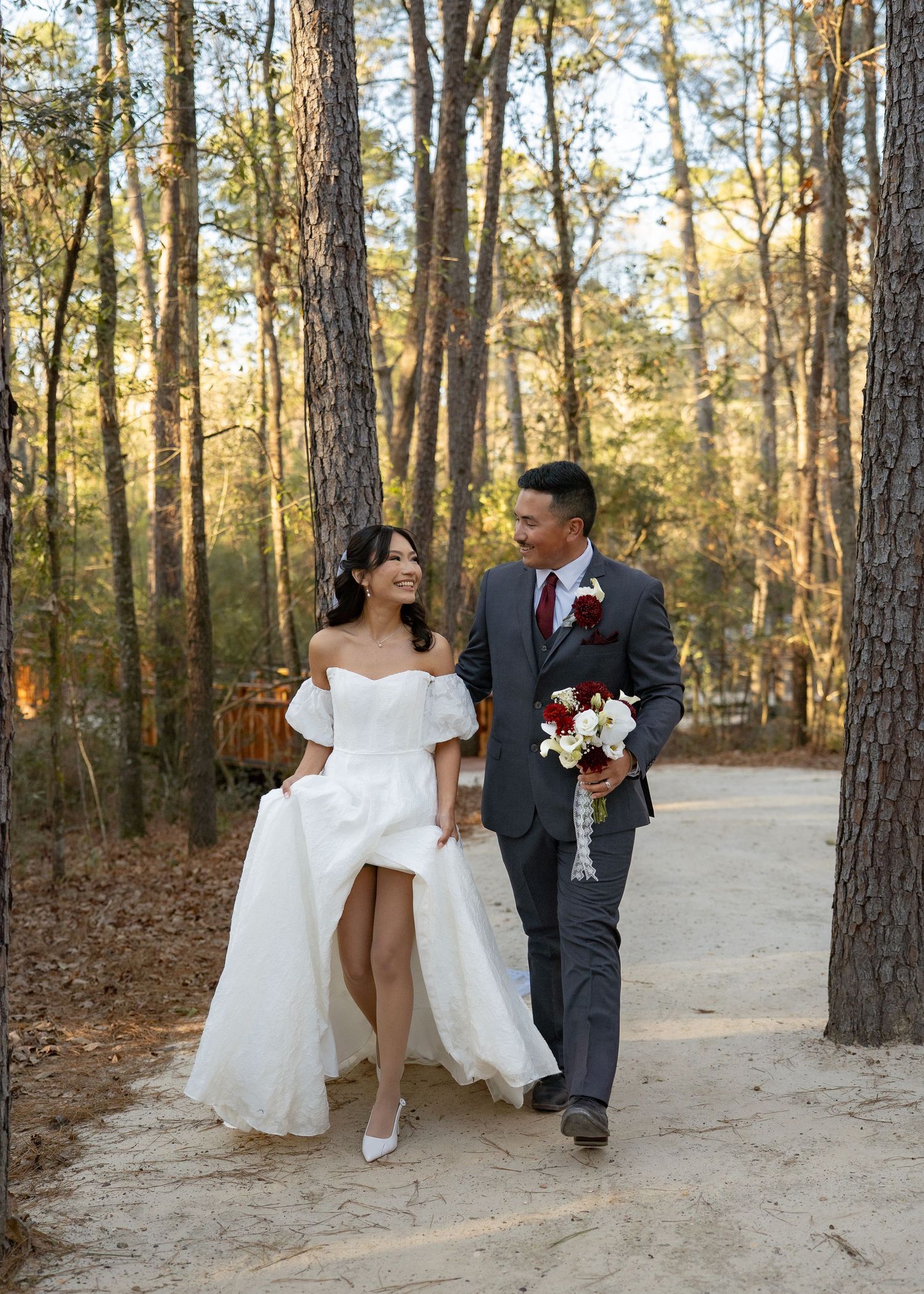 Candid moment of couple laughing together in dense Texas woods at their elopement