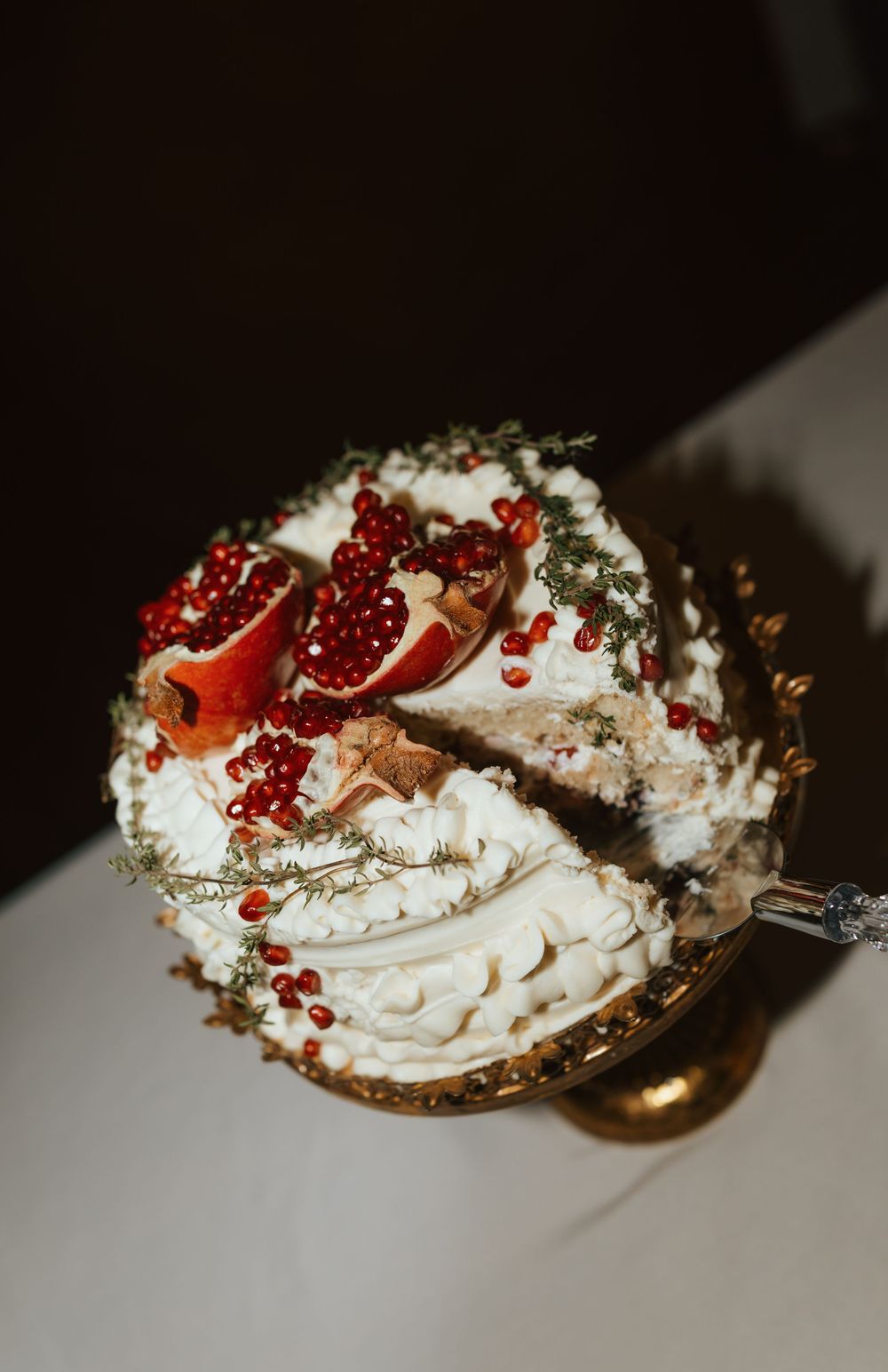 Elegant dessert spoons filled with whipped cream, red currants and edible flowers arranged in a sequence.