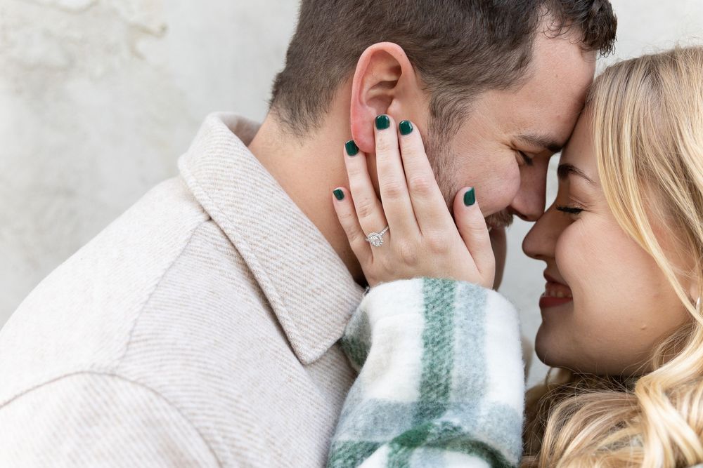 Engaged couple holding each other about to kiss