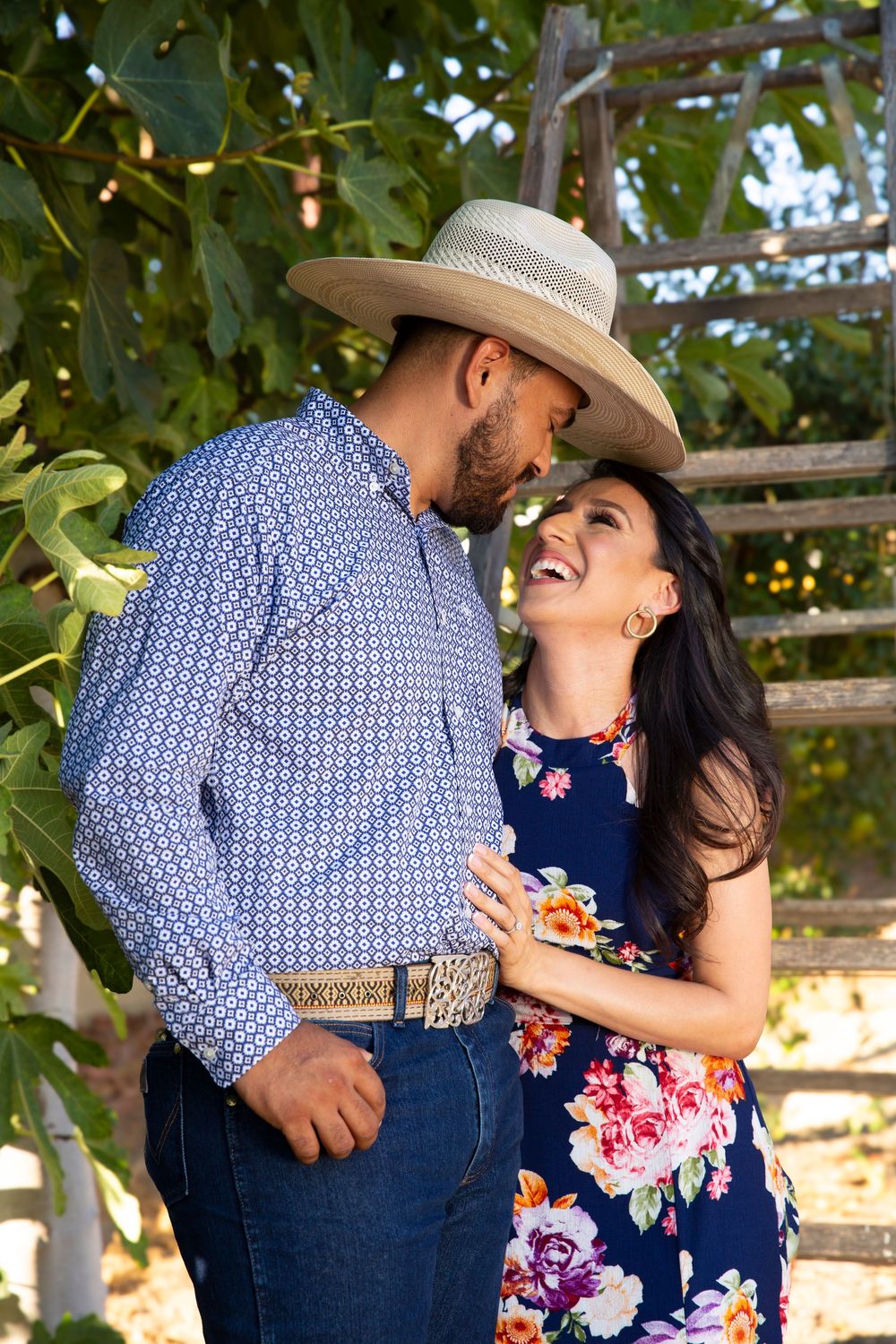 Couple laughing and embracing one another during their outdoor engagement session