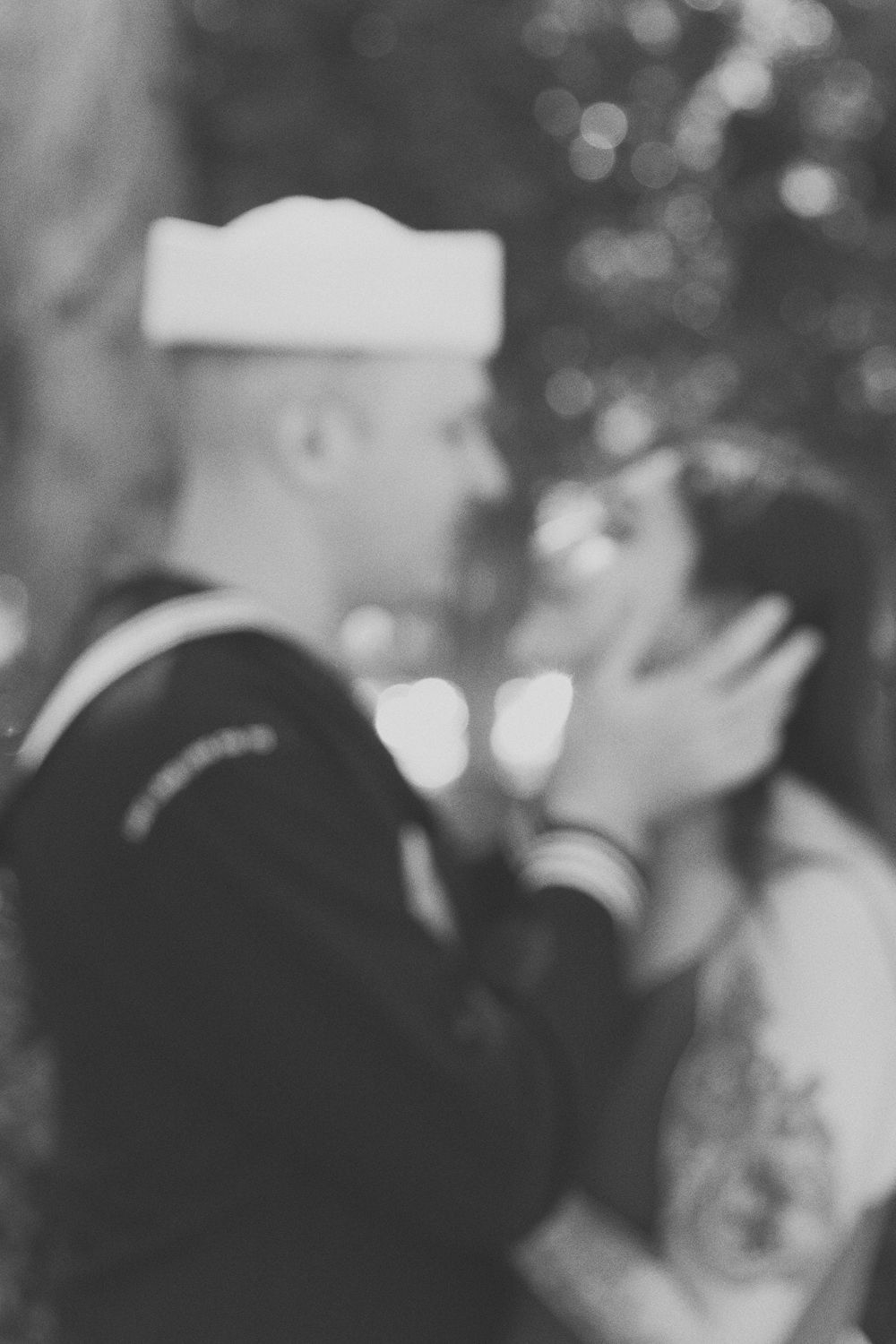 Navy seal holding his fiance while embracing her