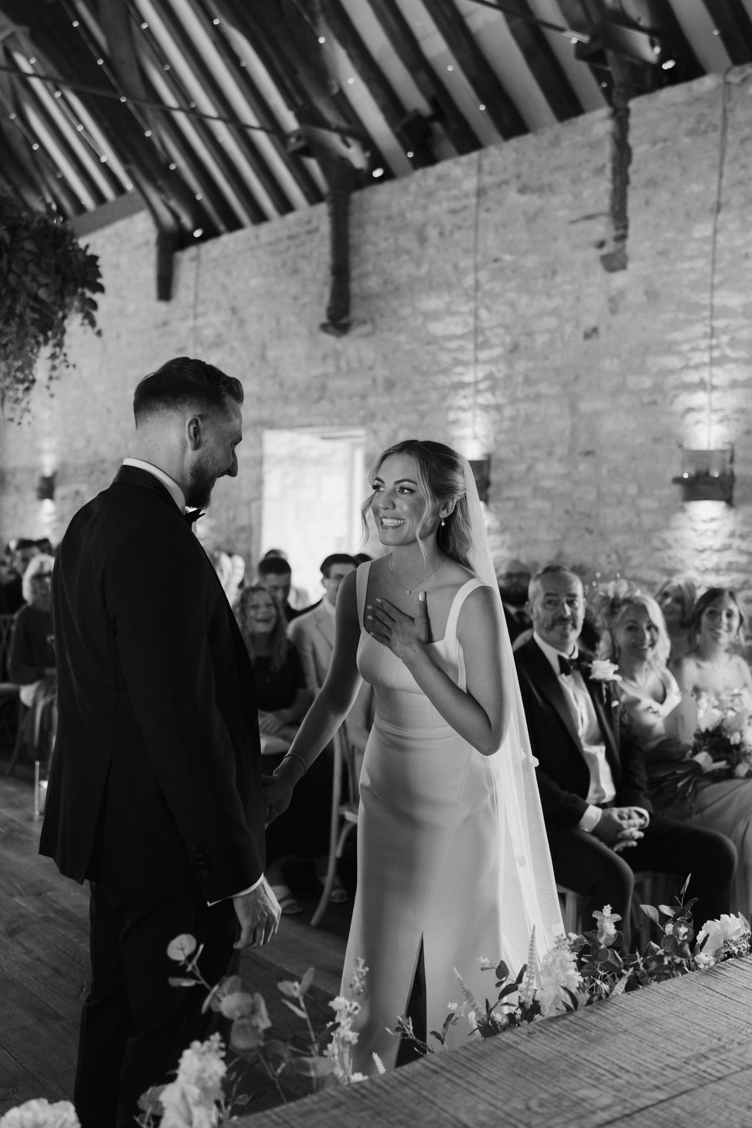 bride laughing looking at groom during ceremony at ivy lodge in cirencester