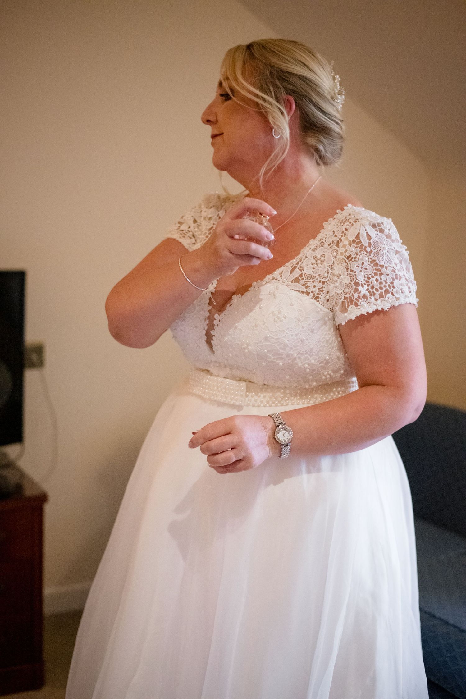 A tender moment between newlyweds sharing their first dance at a wedding reception, with the bride in a white gown.