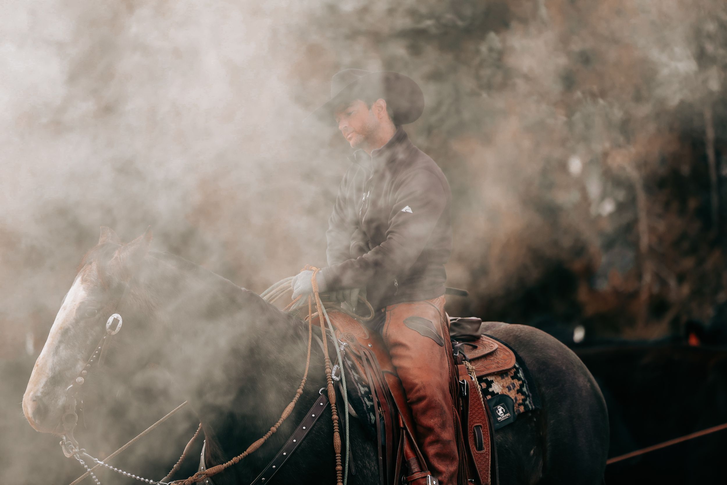 Smoky scene at a western ranch branding in Ellensburg, WA at Flying Box Ranch.