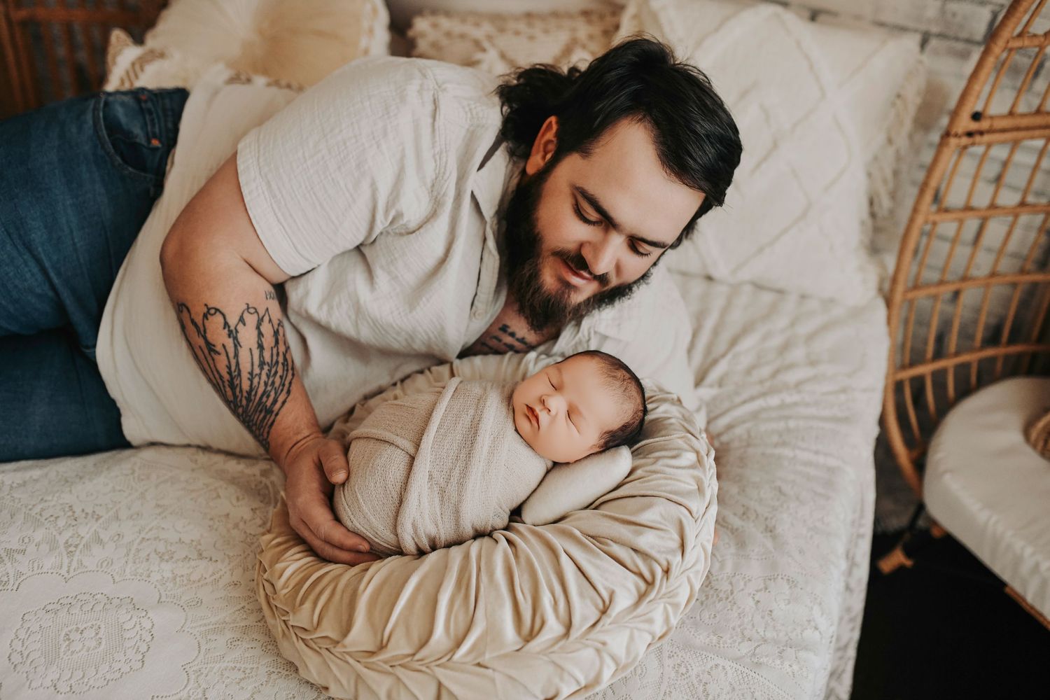 Dad bonding with his baby during an in-home newborn photo shoot