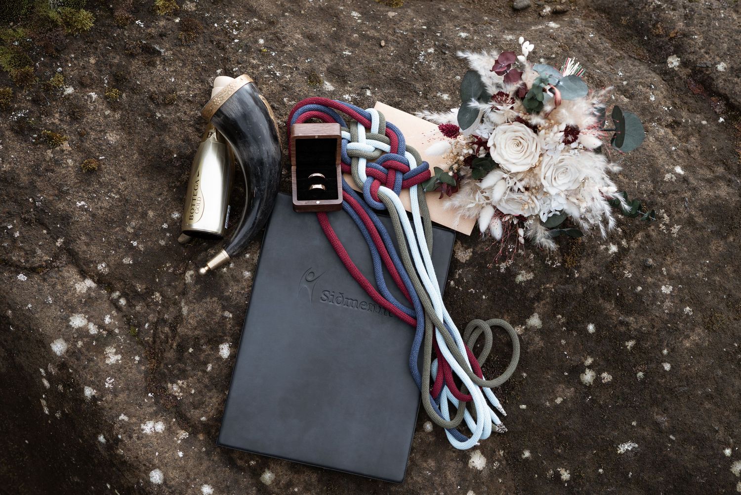 A collection of electronic cables and wires scattered on a rough concrete surface.