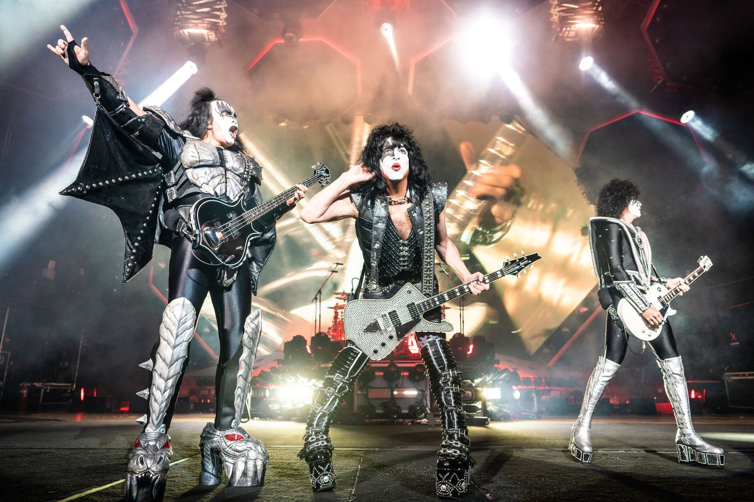 Rock band KISS performs on stage with pyrotechnics and dramatic lighting during an energetic concert performance.