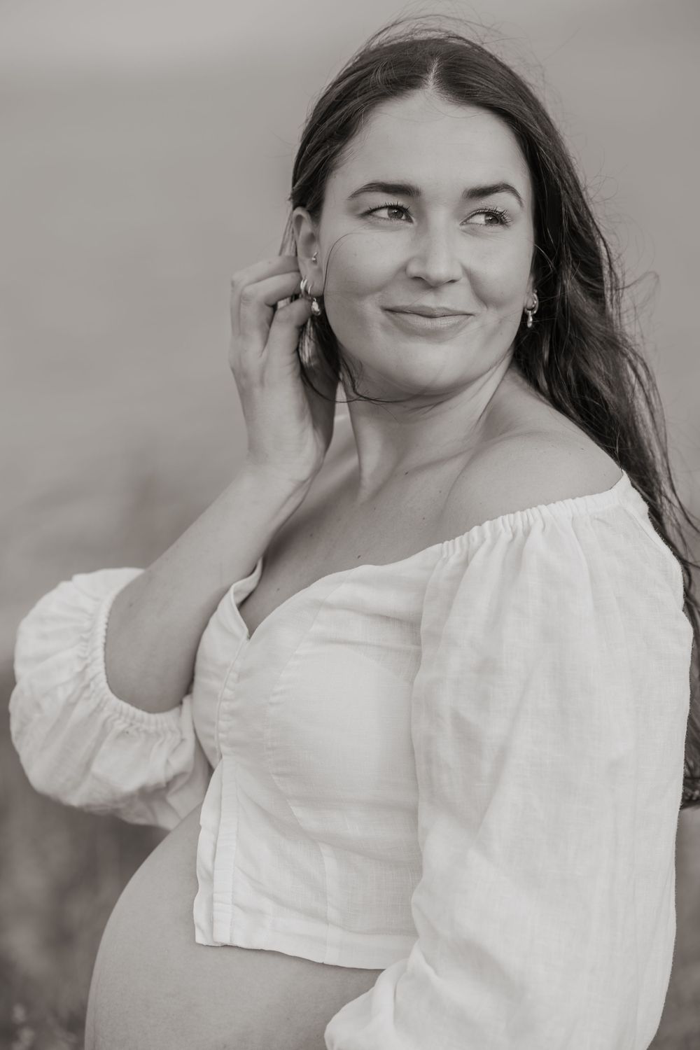 A series of black and white portraits showing a person in a white blouse posing with natural expressions against a gray background.