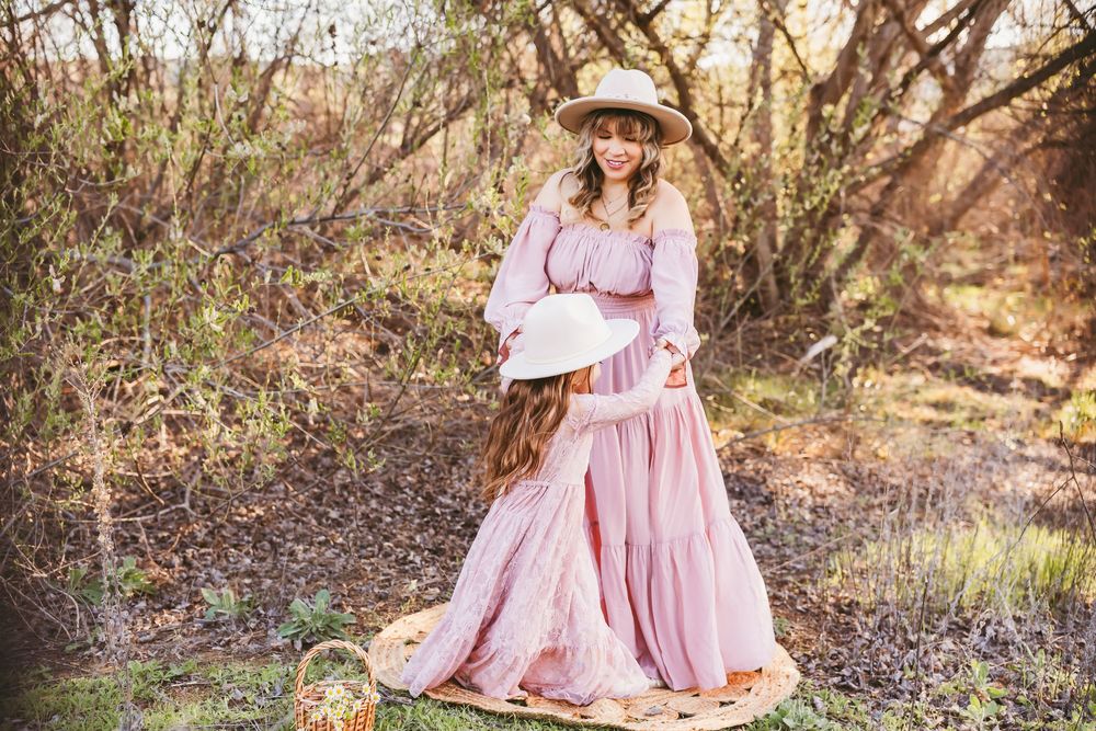 A series of dreamy outdoor photos showing pink dresses and white lace blankets in a rustic woodland setting.