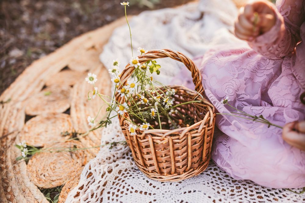 Small wicker baskets arranged on delicate lace doilies with floral decorations.