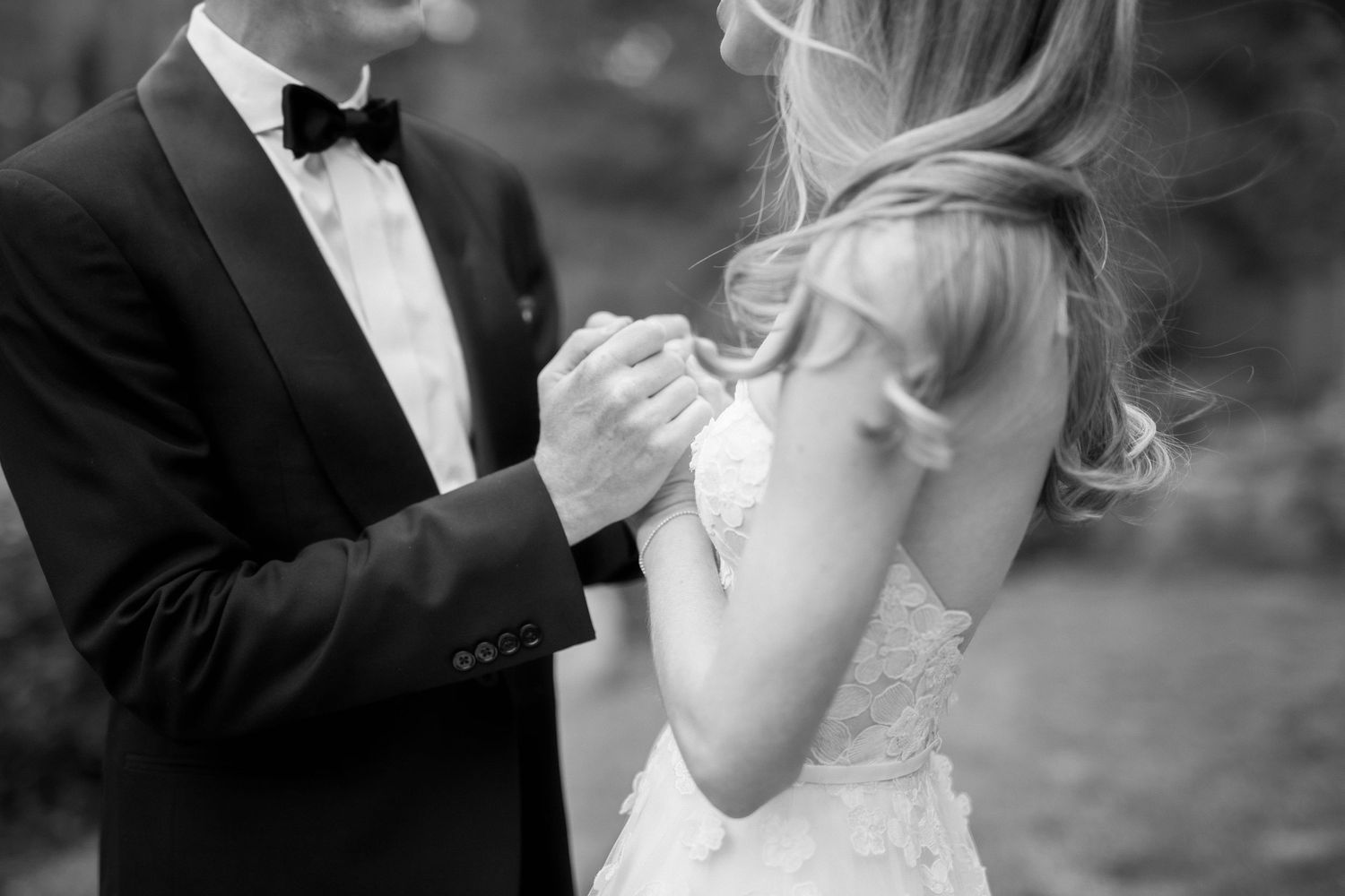 An intimate black and white wedding moment captured in soft focus.