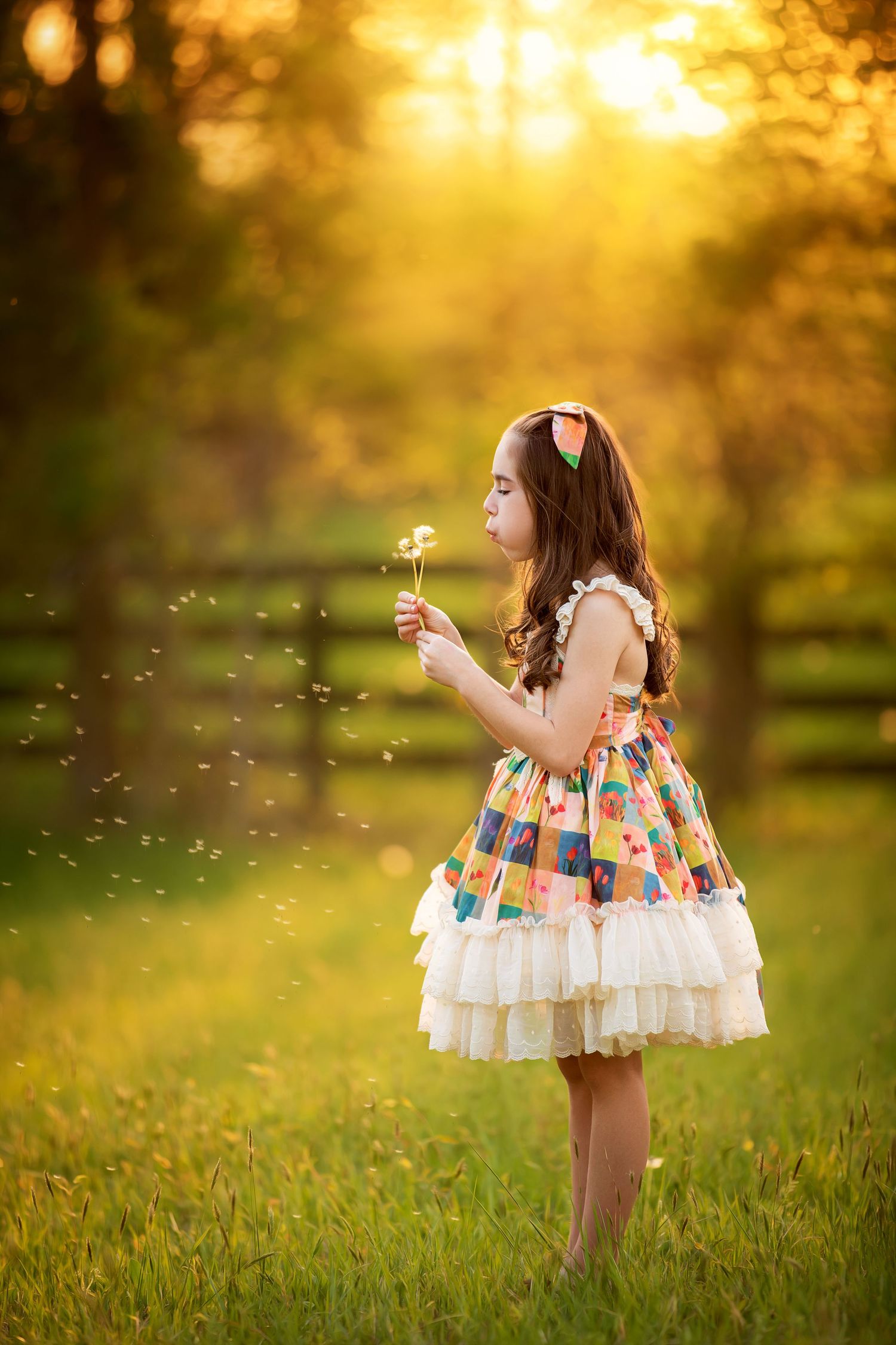 Romantic brown tulle dress captured against dark moody backdrop with dramatic lighting.