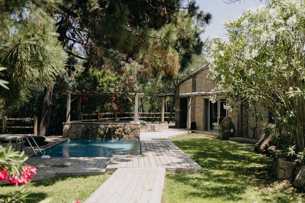 Serene outdoor venue with swimming pool and lush green landscaping.