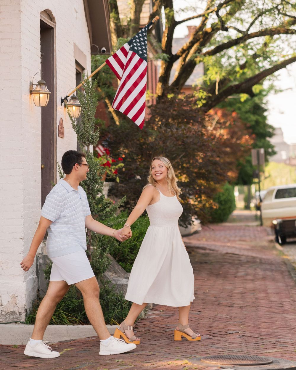 A couple in matching white outfits German Village Columbus Ohio Engagement photos