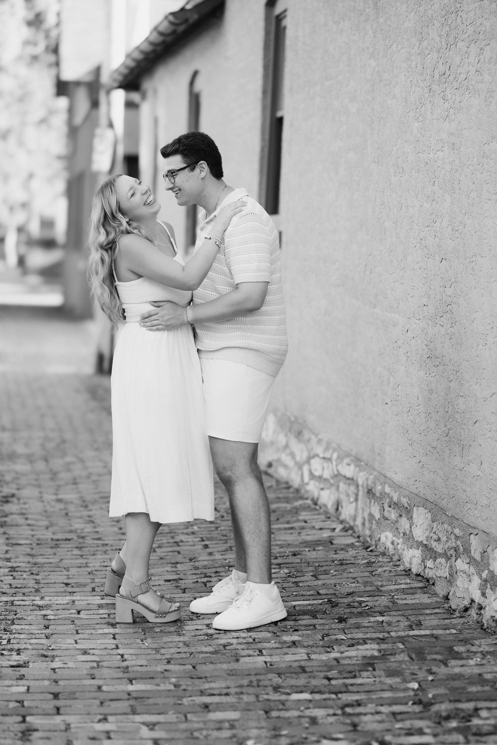 A romantic black and white photo embracing on a cobblestone street. German Village Columbus Ohio Engagement Session.