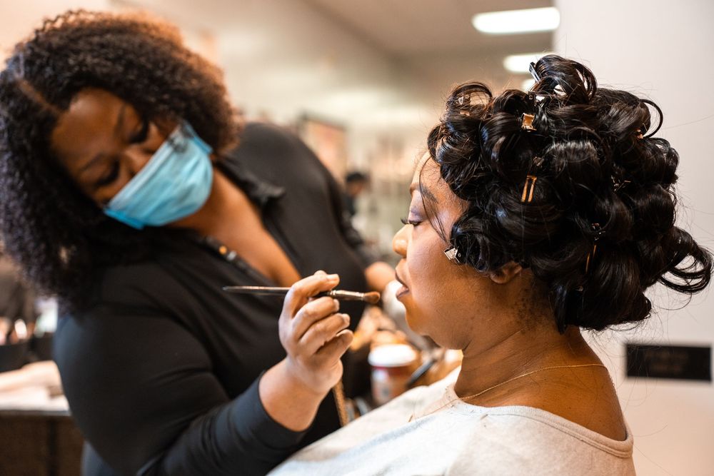 A getting her makeup done before her wedding at Carollwood Country Club in Tampa, Florida