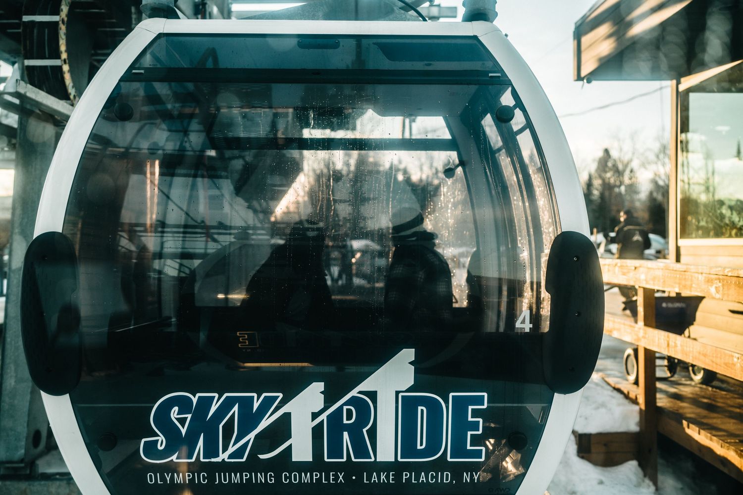 A row of empty subway train cars with glass windows and doors viewed from the platform at a transit station.