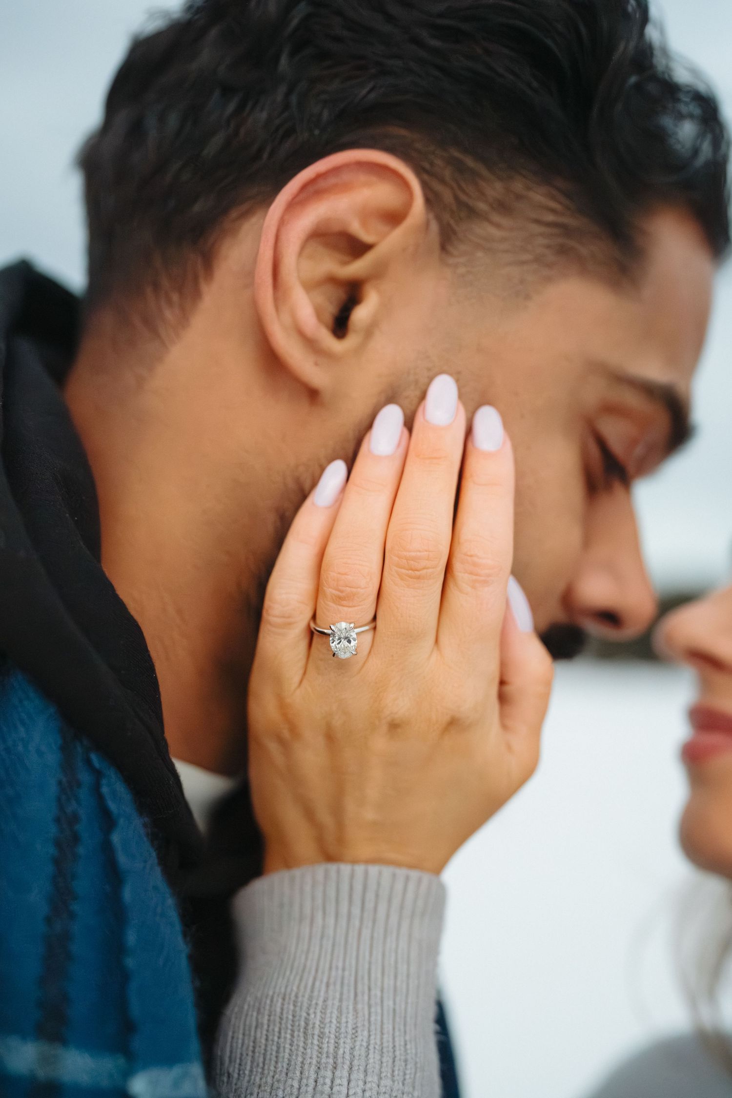 A series of close-up photos showing hands covering a face, with a diamond engagement ring visible.