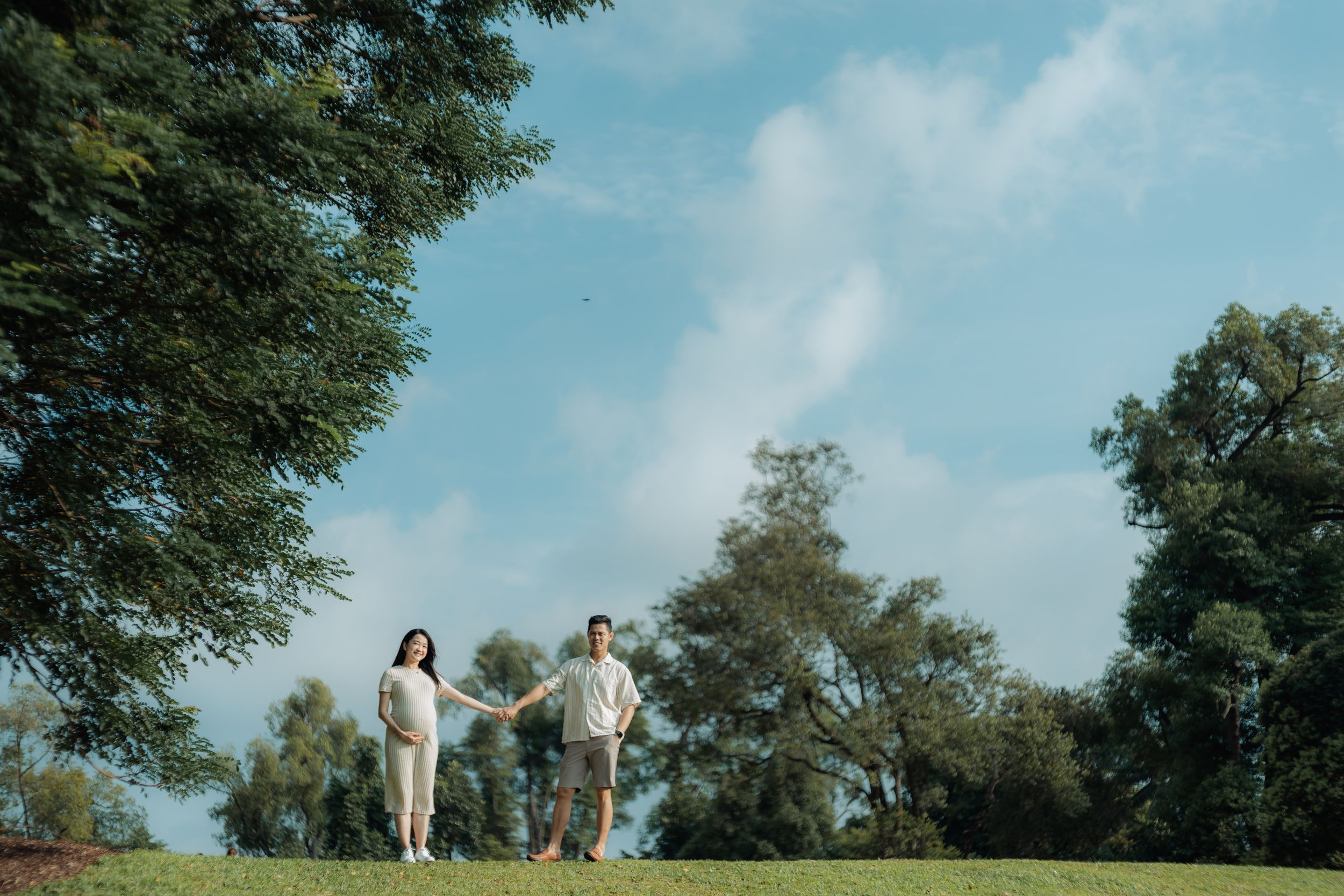 Scenic outdoor photo session with trees and blue sky in natural setting.