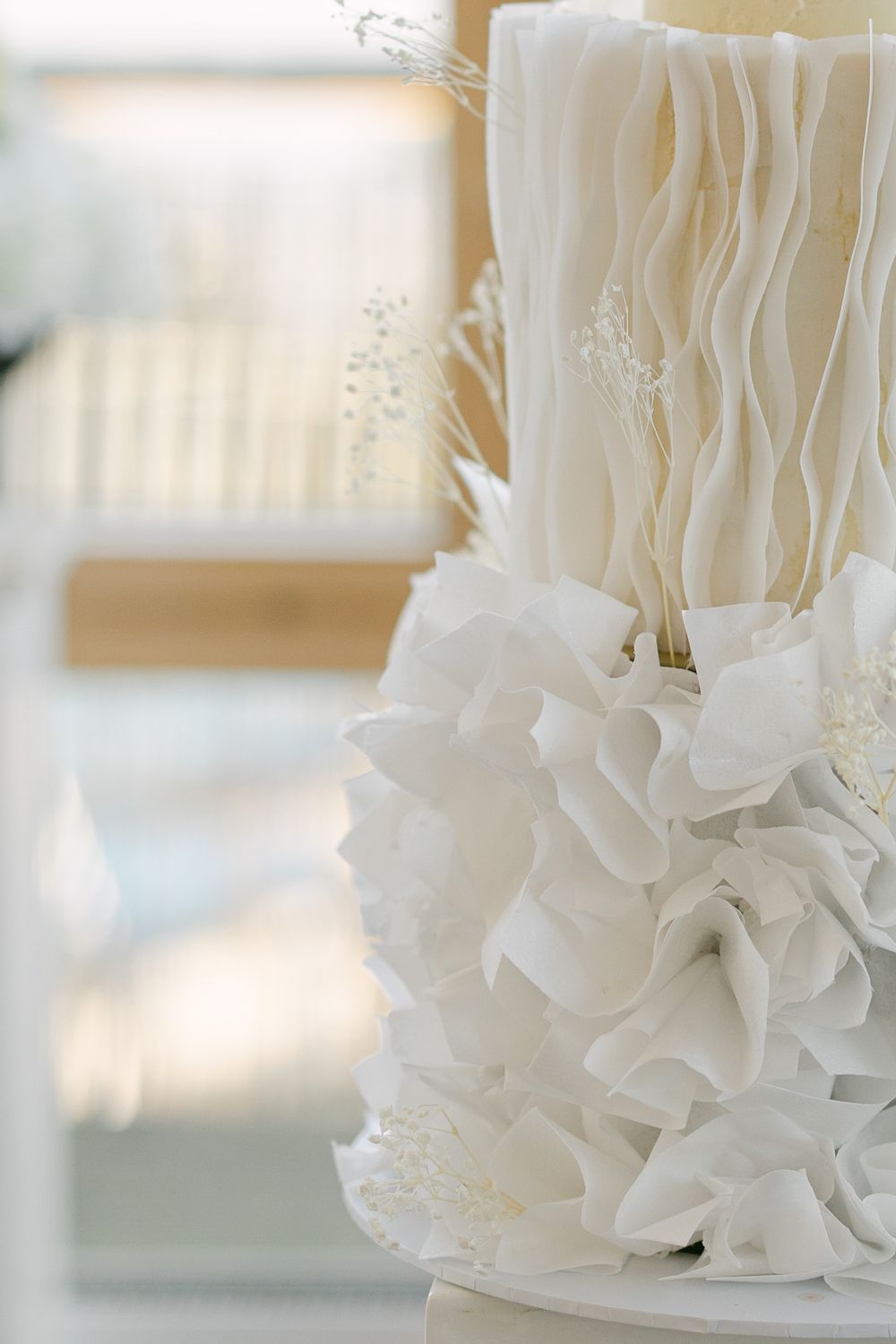 Close-up details of delicate white ruffled fabric with soft lighting creating an elegant, ethereal effect.