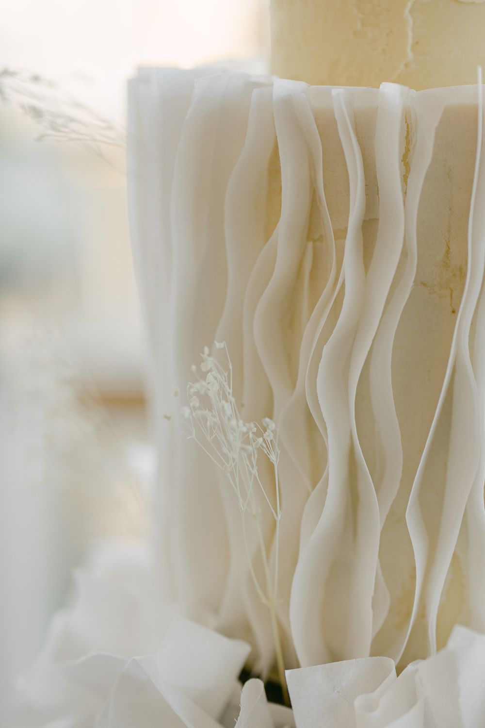 Close-up of flowing white fabric drapes creating an elegant wedding backdrop.