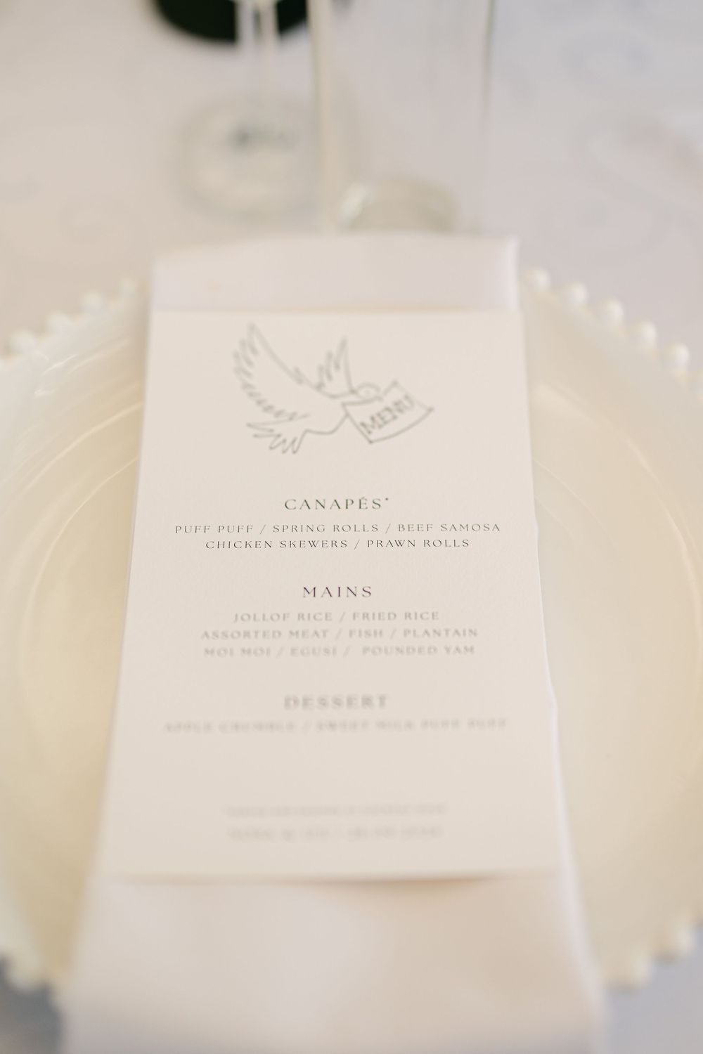 Wedding menu cards with dove design featuring canapes and mains listings.
