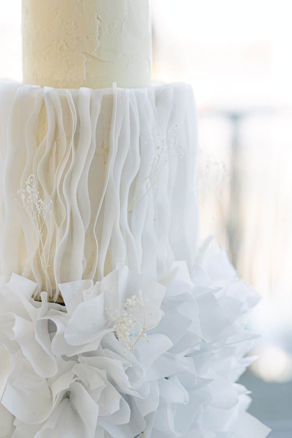Close-up of delicate white ruffled fabric details with soft dreamy lighting.