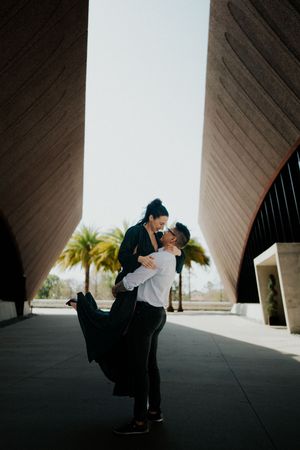 Artistic black and white photo series showing silhouettes of two figures embracing under geometric architectural angles.