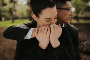 A couple shares an intimate moment together during their engagement photoshoot in a natural outdoor setting.