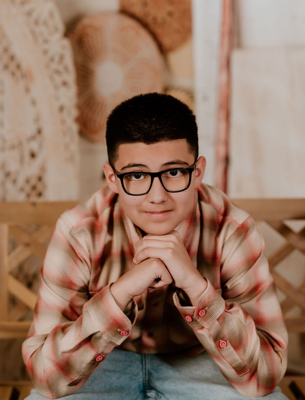 A series of portraits showing someone in glasses and a striped sweater making playful expressions.