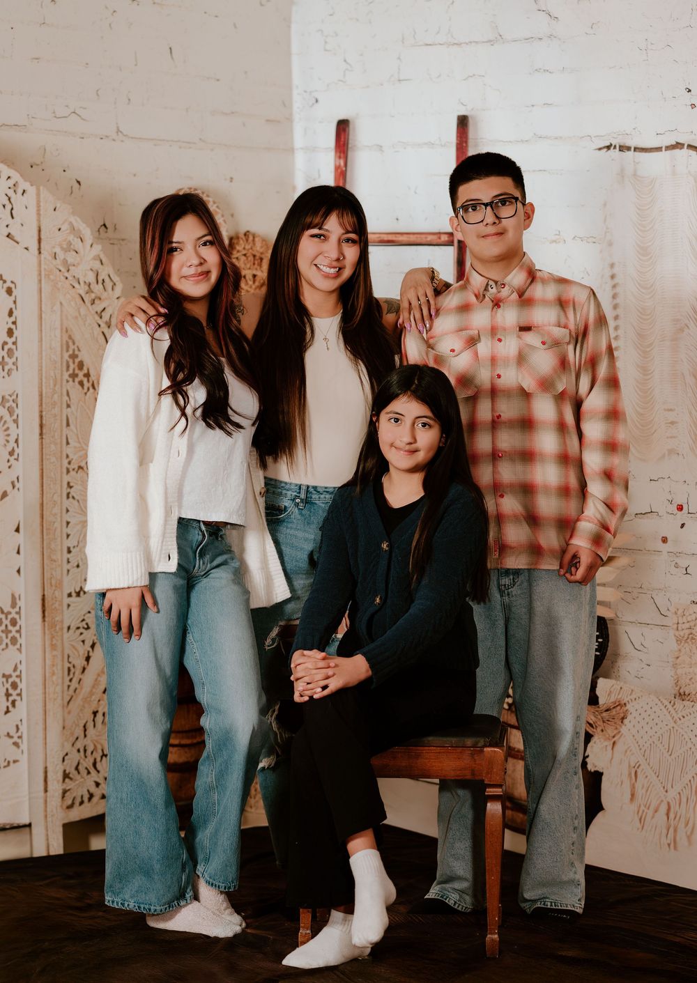 A casual group photo series showing people in casual attire posing together against a white wall.