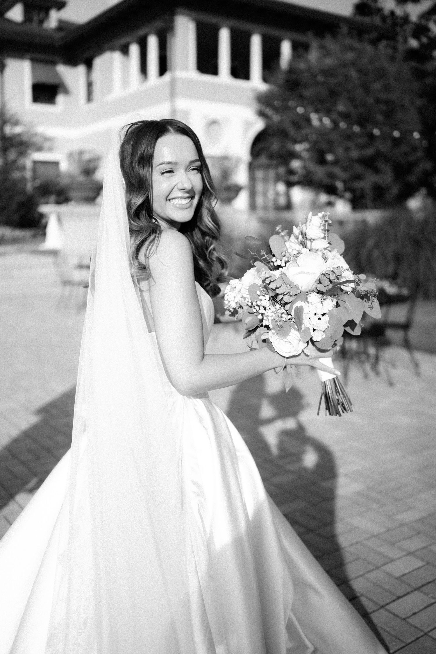 A series of black and white wedding photos showing a bride in a flowing white dress holding a floral bouquet.