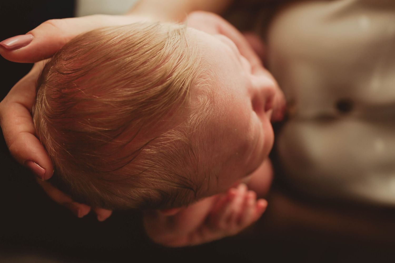 Close-up macro photographs of a baby's tiny hands and feet arranged in a series of artistic shots.