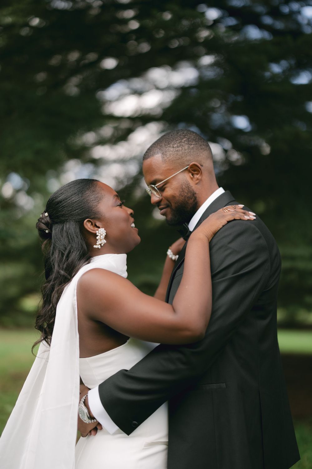 Intimate wedding moment captured between couple embracing outdoors.