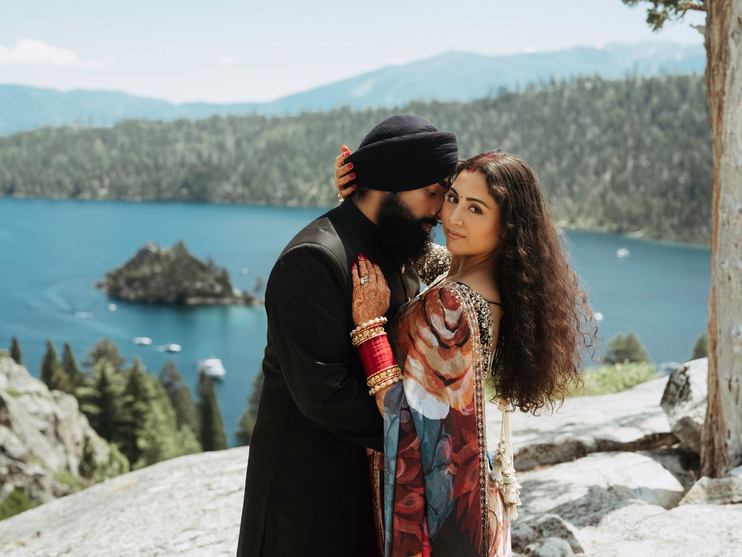 Romantic couple shares intimate moments against stunning mountain lake backdrop at Emerald Bay, Lake Tahoe.