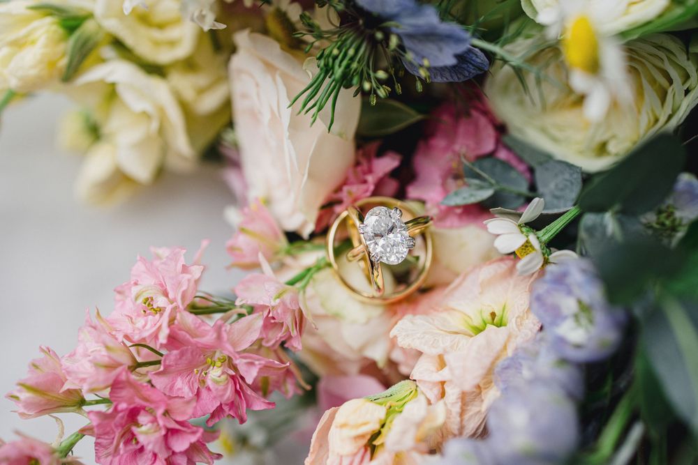 Close-up of romantic wedding floral arrangement with pink and cream blooms.