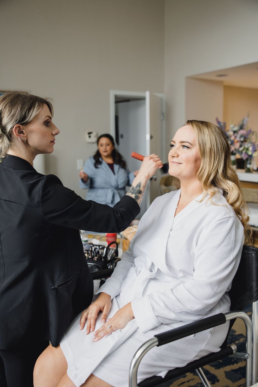 Wedding preparation scene with styling session in a bright room.