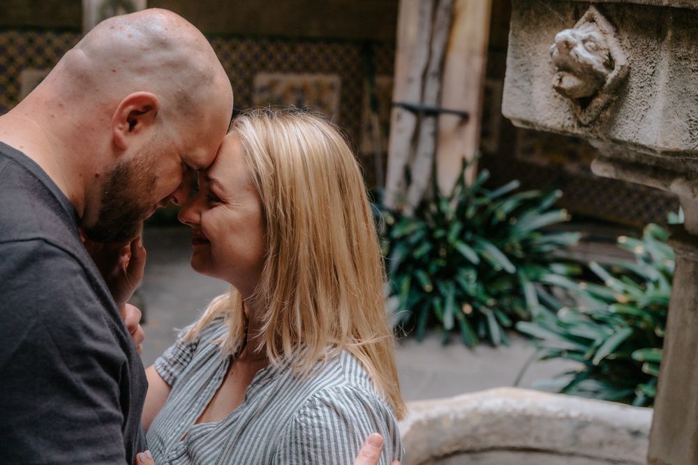 Joyful couple spinning in Gothic Quarter Barcelona Natural couples photoshoot BarcelonaLoversPH