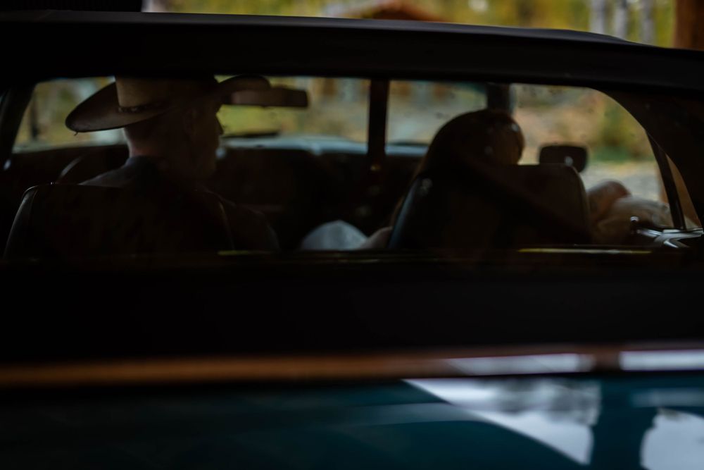 Silhouetted view through a car window during golden hour.