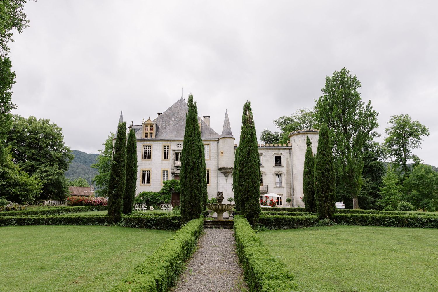A series of panoramic views showing a white mansion with cypress trees and manicured gardens in the French countryside.